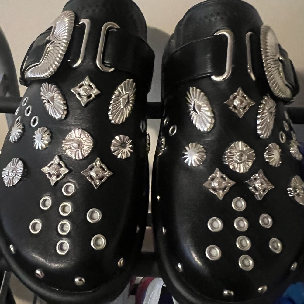 Black leather mules with metal fittings